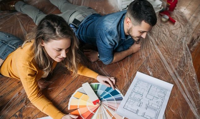 Transform Your Home: 5 Renovation Ideas to Increase Property Value A couple planning home renovations, selecting paint colors and reviewing plans to boost their Calgary home's value